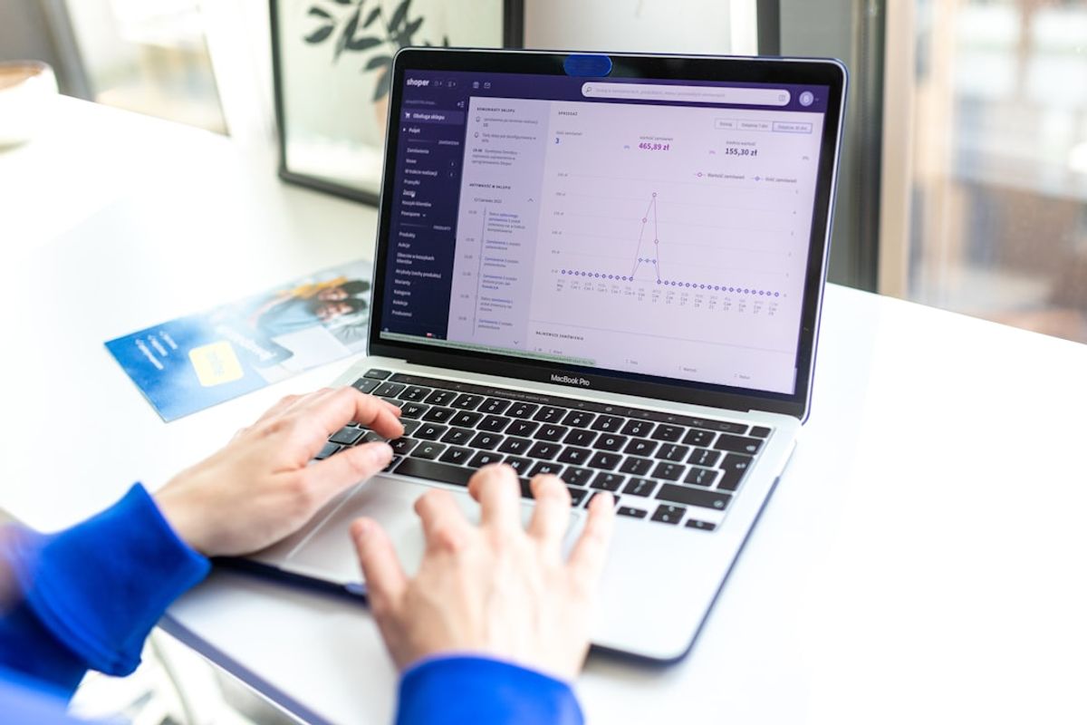 Seseorang menganalisis data keluaran di laptop