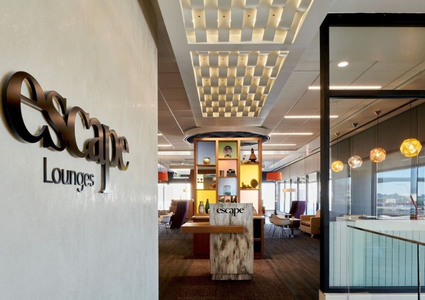 Modern Escape Lounges interior showing a prominent sign, reception desk, and elegant contemporary design.