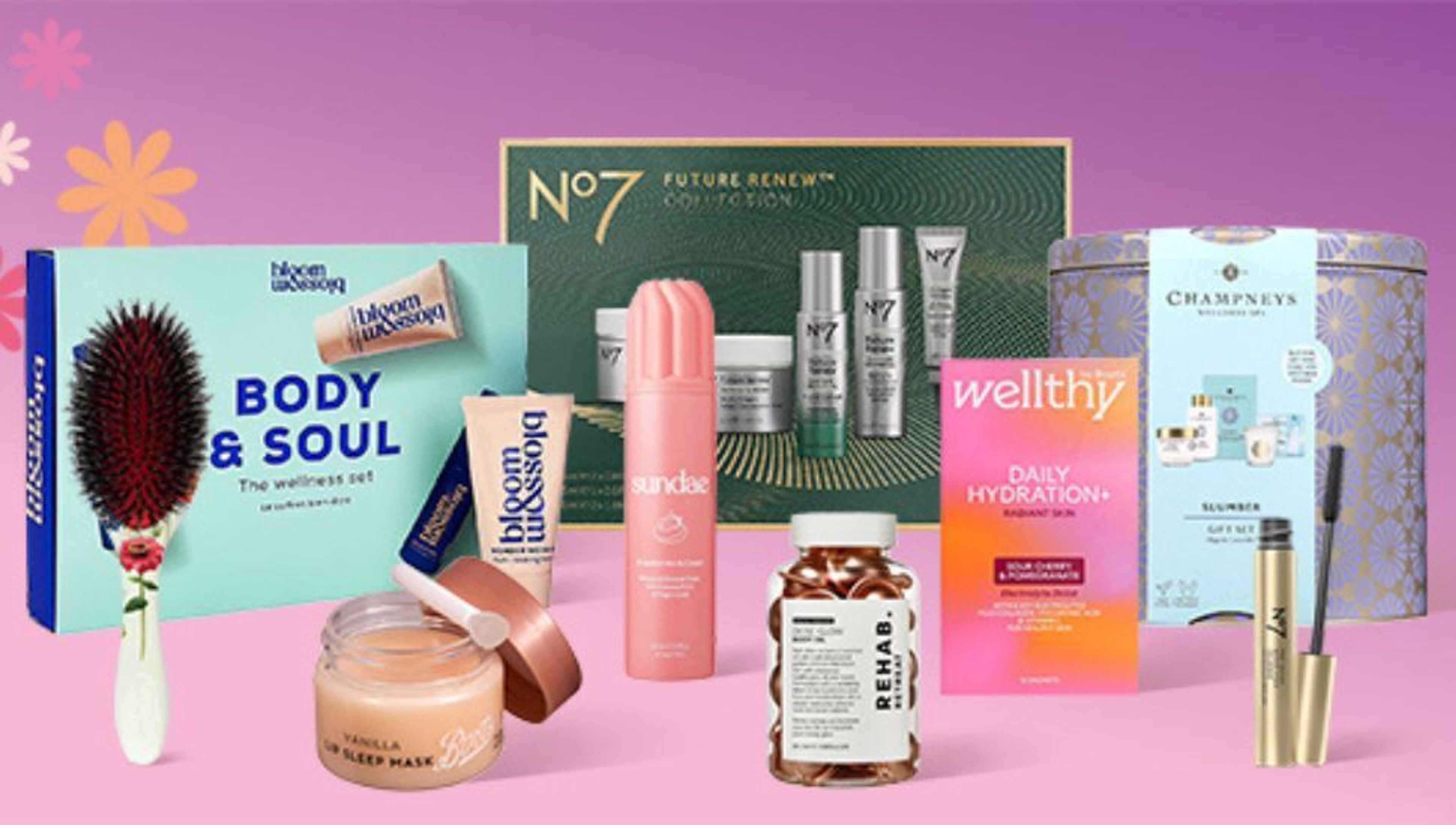 Beauty and skincare products and gift sets, including perfumes and creams, displayed on pink gift boxes.