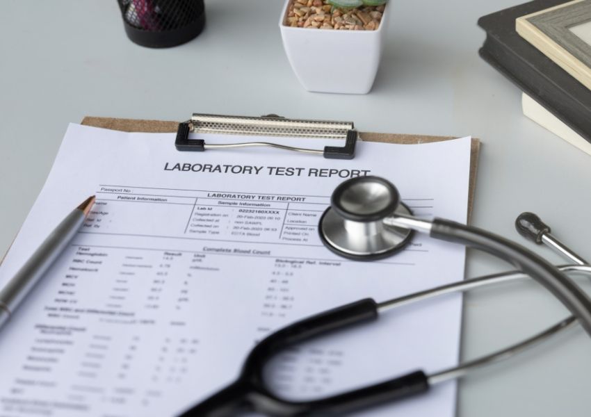 A laboratory test report with a stethoscope and pen.