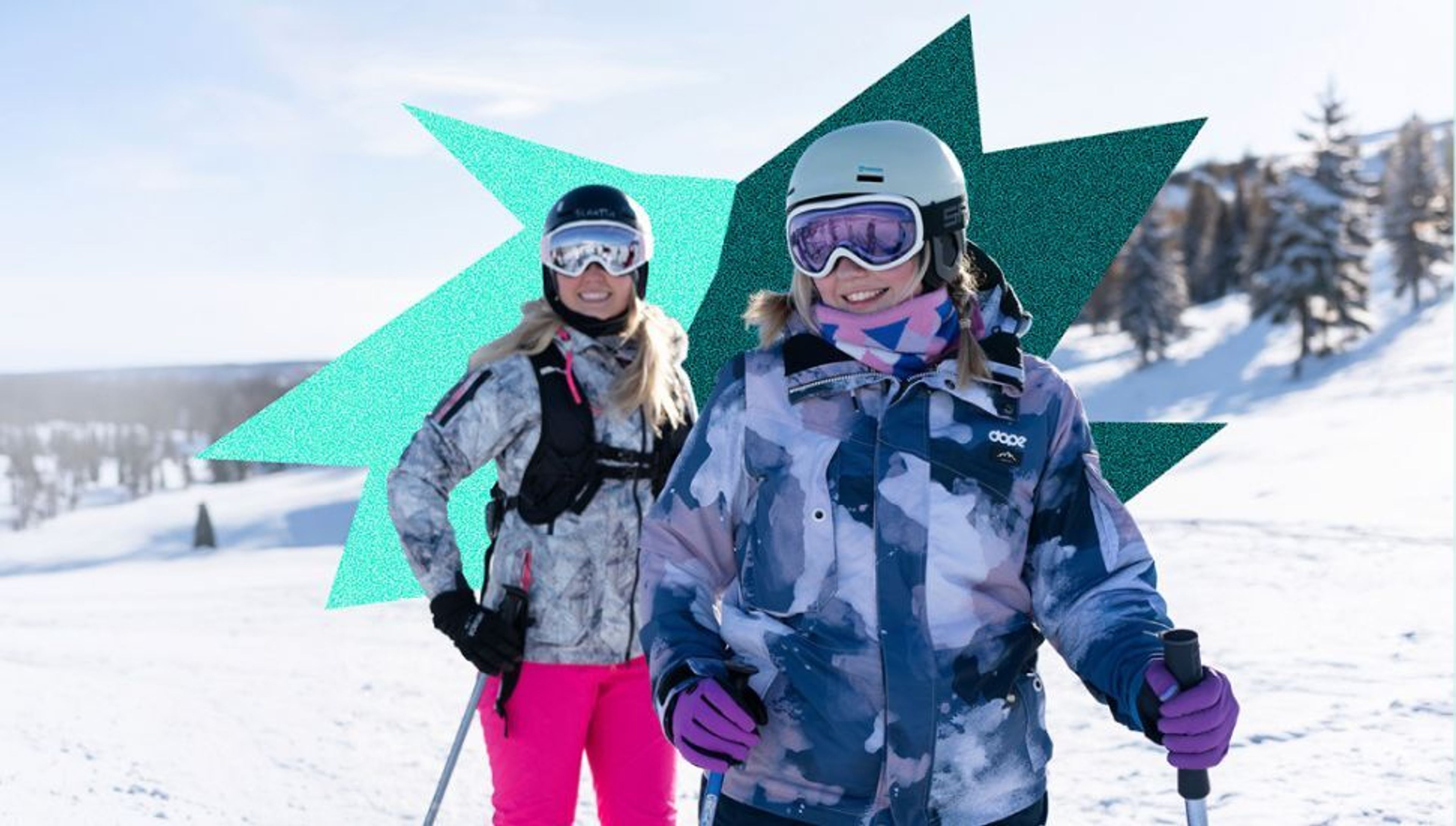 Two smiling women in ski gear on a snowy mountain.