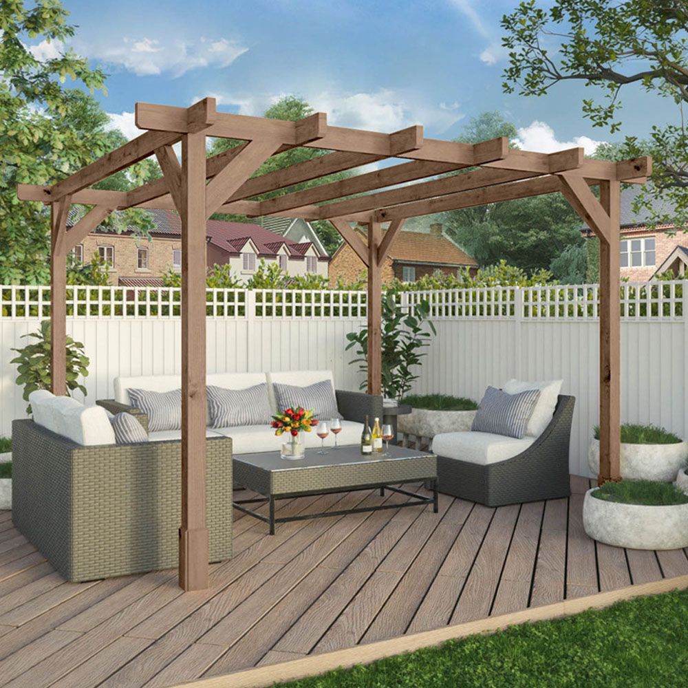 A wooden pergola over a furnished deck in a backyard.