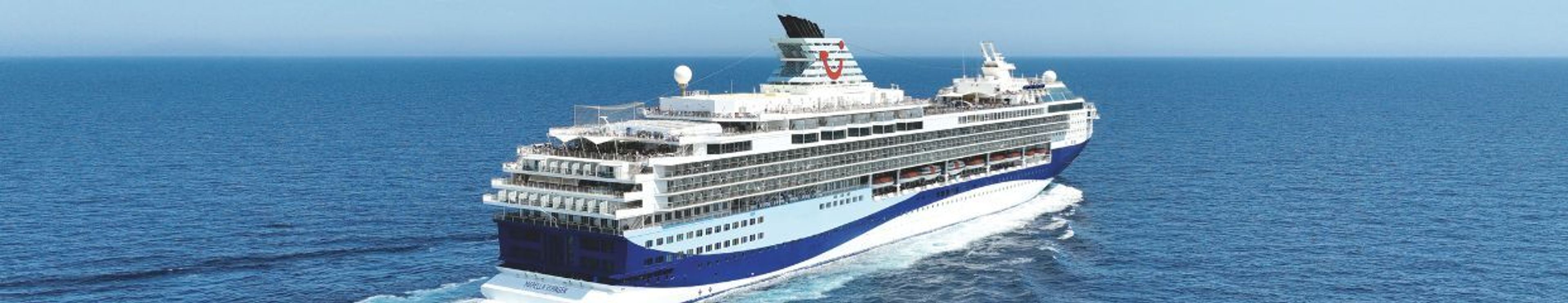 White and blue TUI cruise ship sailing on the ocean.