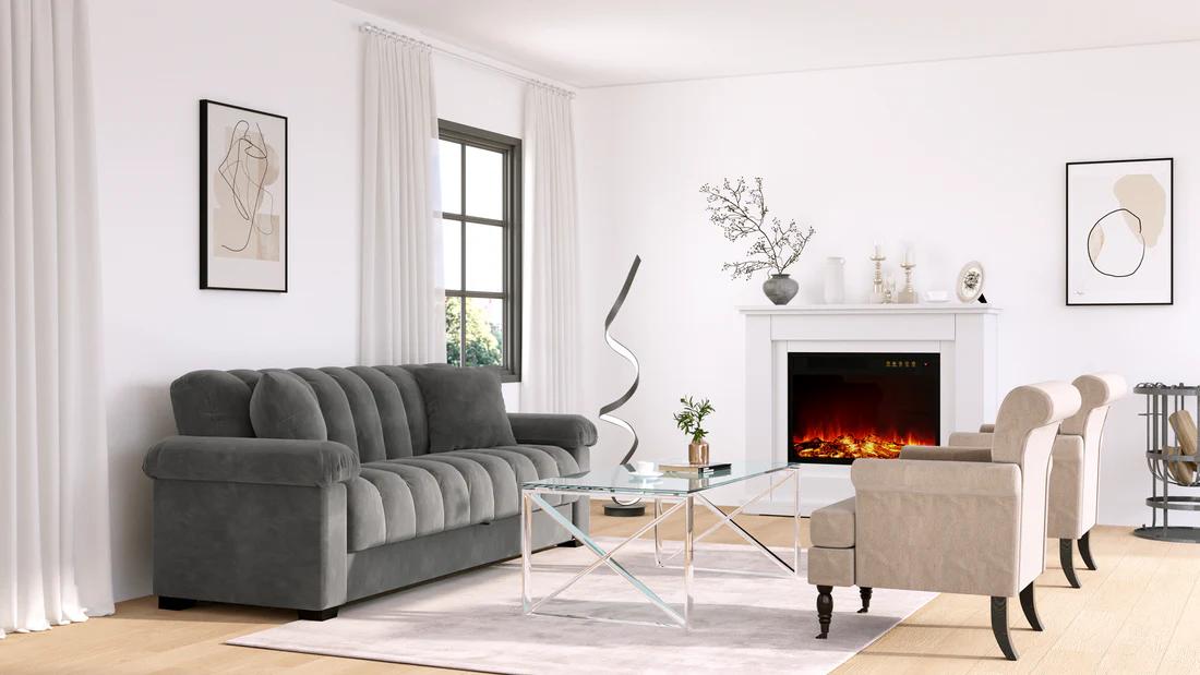 A modern living room with a gray channel-tufted sofa, two beige armchairs, a glass coffee table, and a white fireplace.