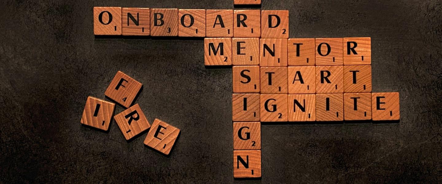 scrabble board containing the words onboard, mentor, start, ignite and no resign
