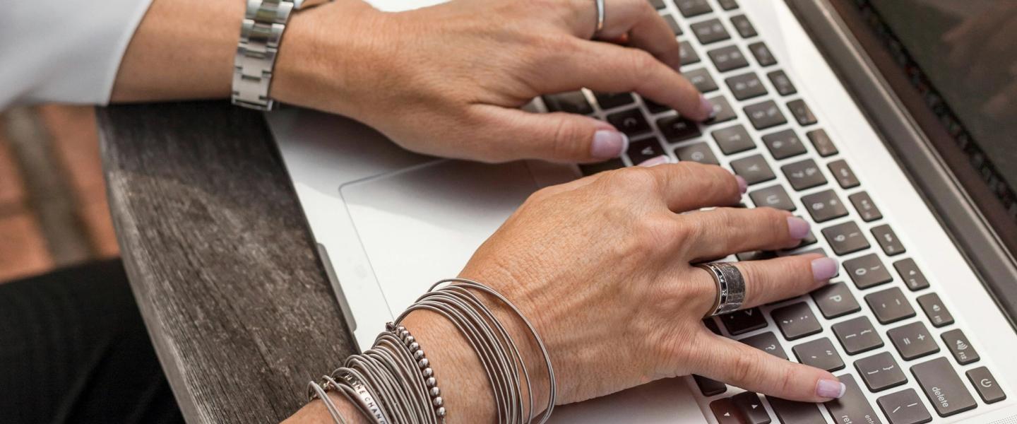 hands typing on a laptop
