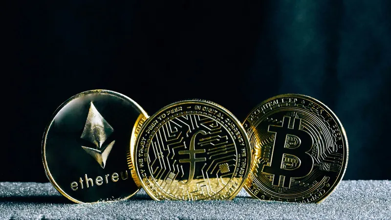 Three physical cryptocurrencies standing upright.
