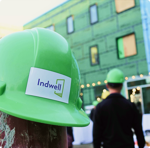 A green hardhat with the Indwell logo on it.