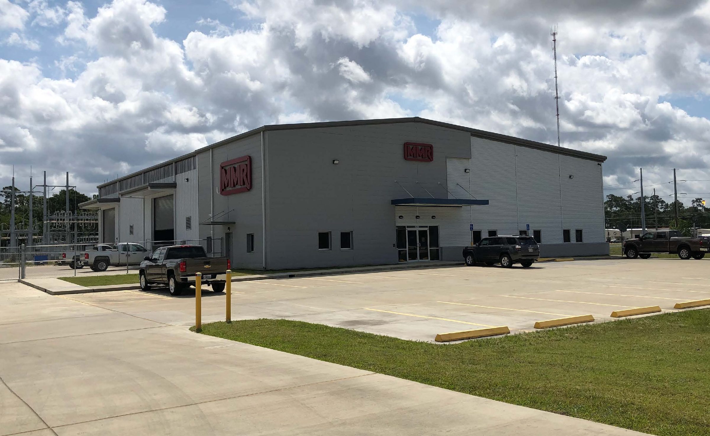 Long industrial building with a loading area and yard