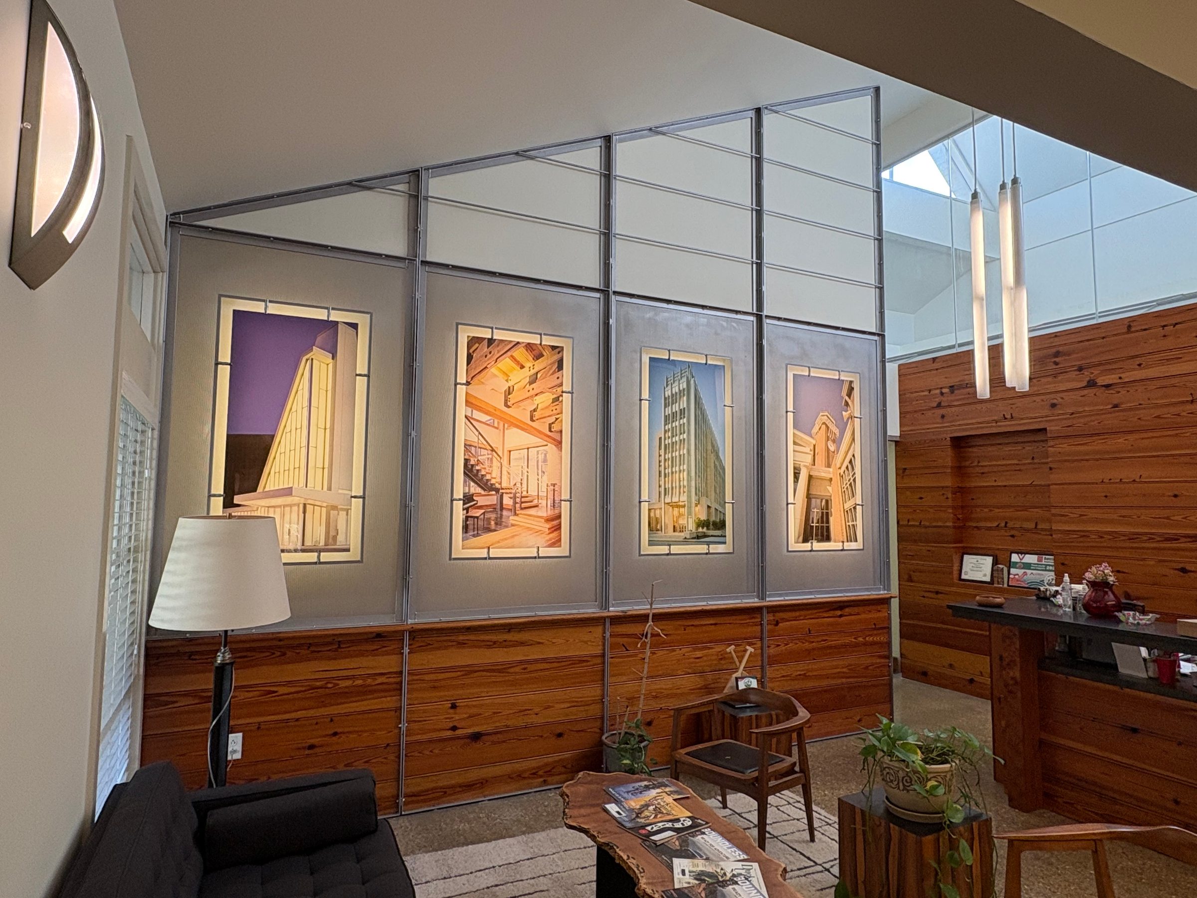 Lounge at Ratcliff Companies headquarters, wood-panelled with framed architectural drawings