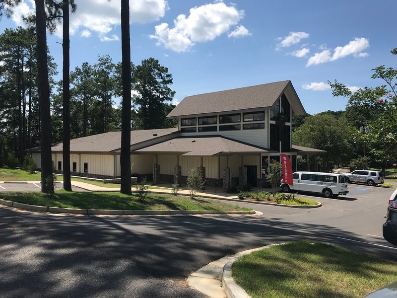 Church building set among tall pine trees