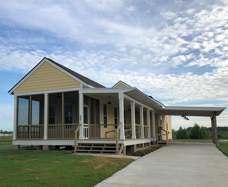 Raised residence with a deep screened porch