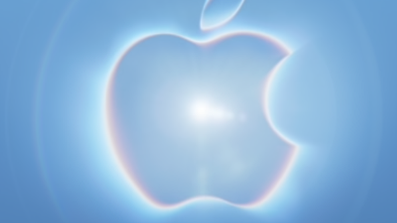 The image features a stylized Apple logo illuminated against a soft blue background, creating a sense of mystique and anticipation. The glowing effect highlights the brand's iconic design, evoking themes of innovation and excitement.