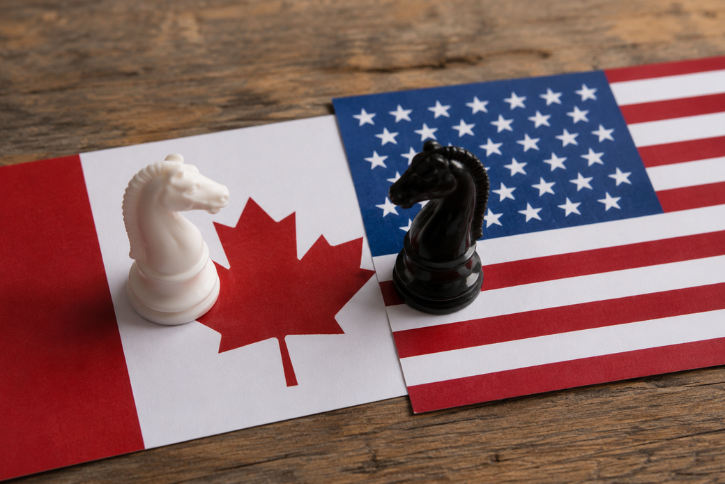 The image features a white chess piece and a black chess piece positioned on top of Canadian and American flags. The chess pieces symbolize strategy, while the flags represent the two countries.