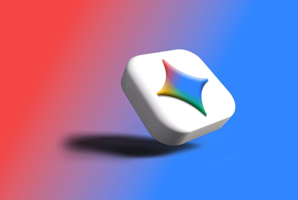 The image features a stylized, three-dimensional logo on a gradient background that transitions from red to blue. The logo consists of a star-like shape with multiple colors, suggesting a modern and dynamic design. — Credit: Photo by Rubaitul Azad on Unsplash