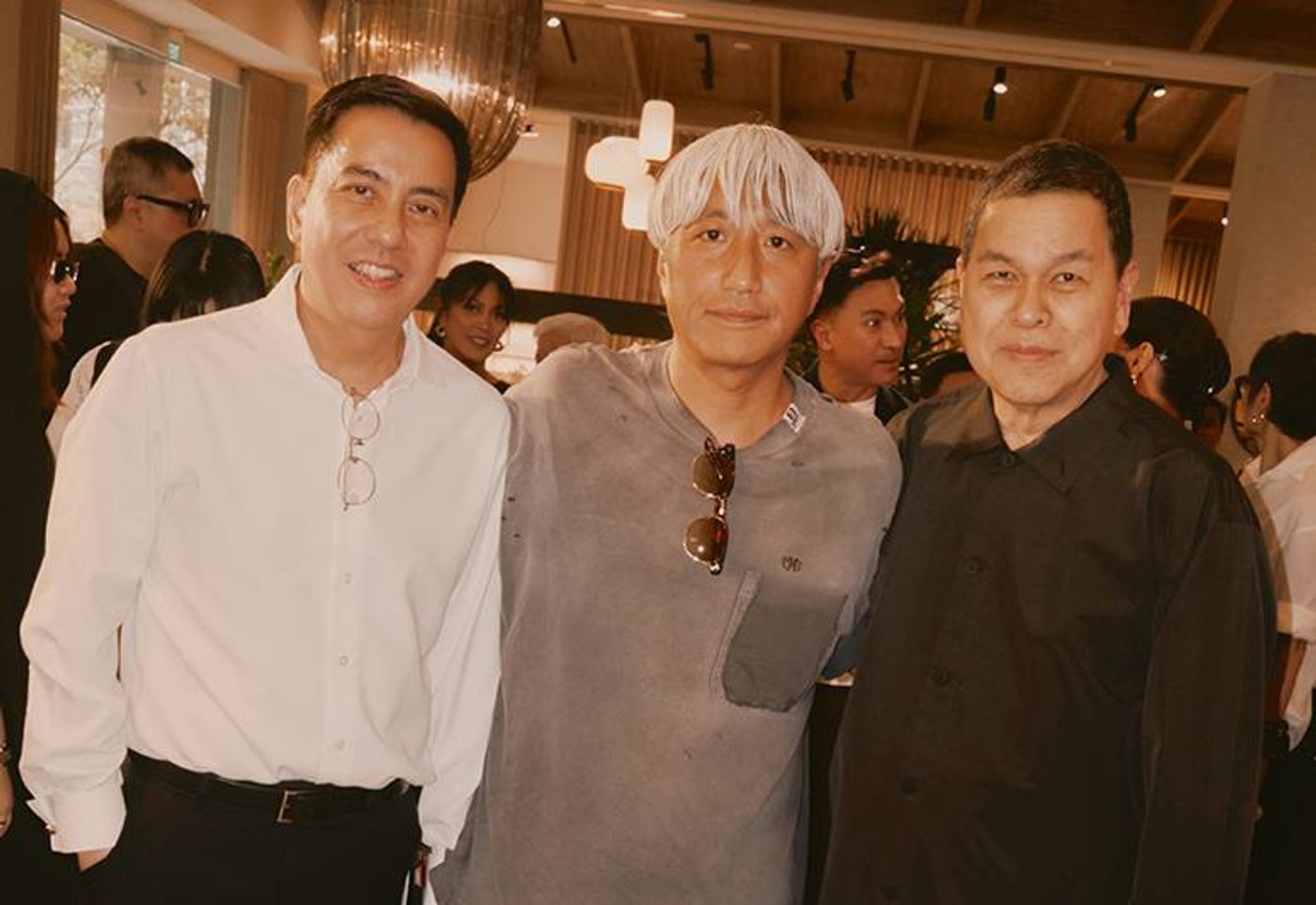 Suyen Corp. chairman and CEO Ben Chan, Japanese designer Mihara Yasuhiro, and VP Bryan Lim posing together in front of a modern furniture display
