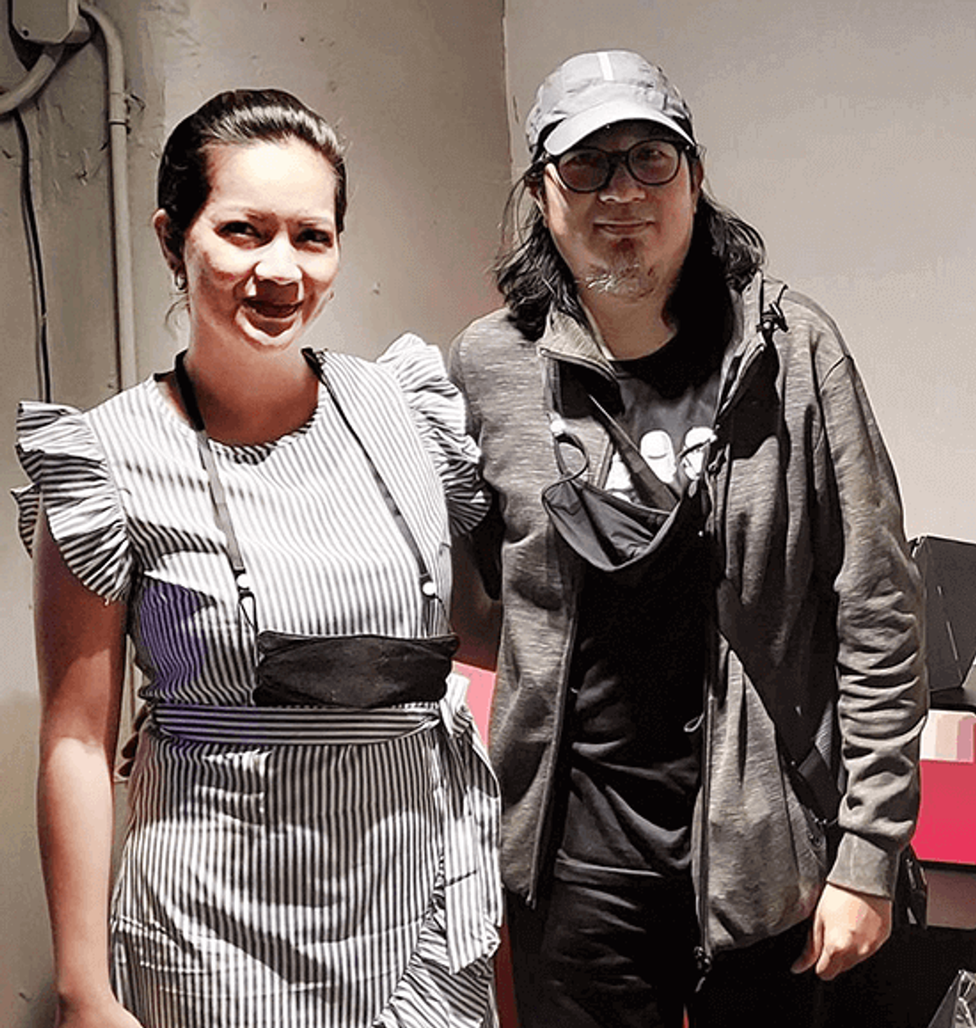 Joanne Enriquez in a striped ruffled dress with Julius Sanvictores in a cap and gray hoodie