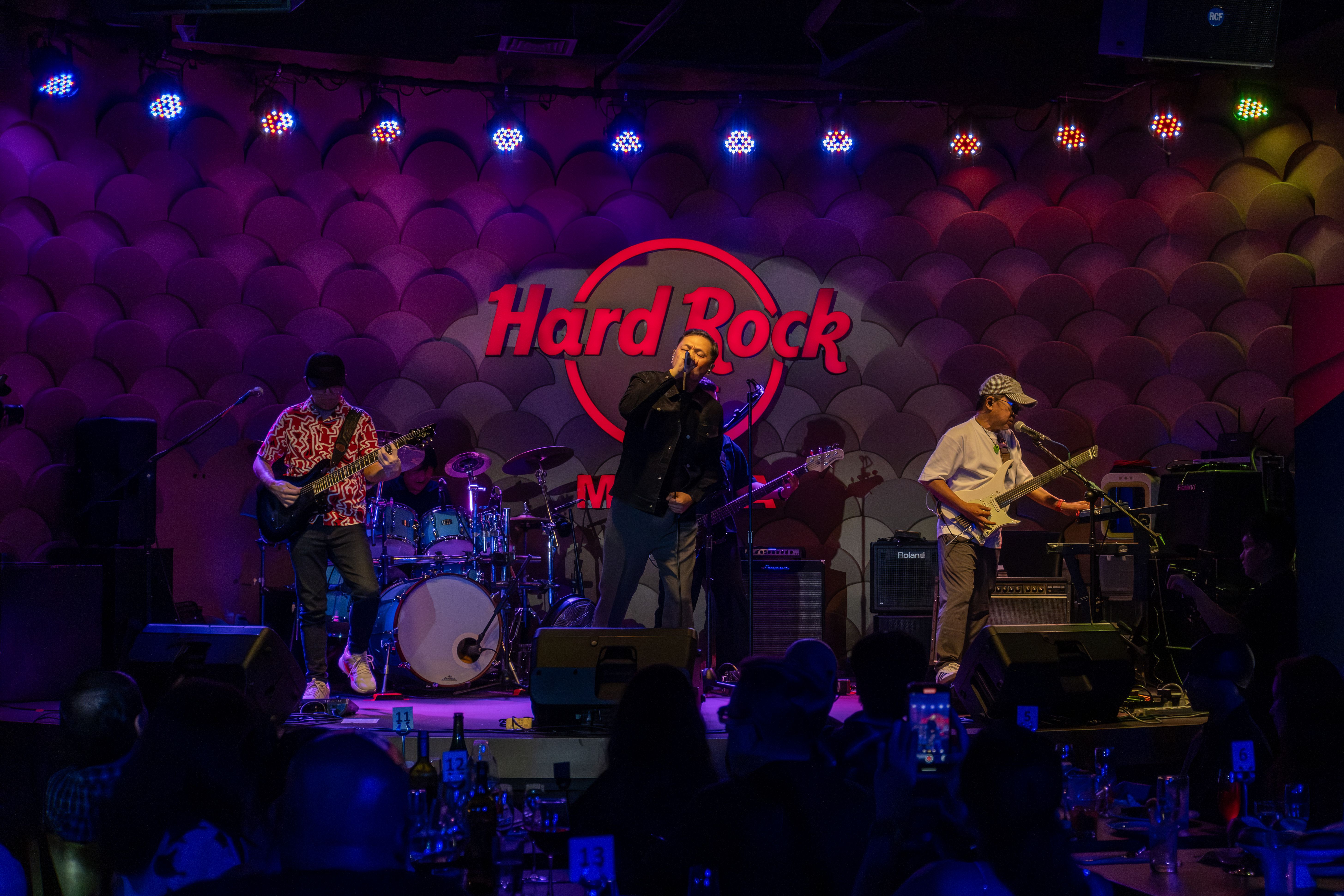 The Dawn perform on the Hard Rock Cafe Manila stage under colored lights at the anniversary party