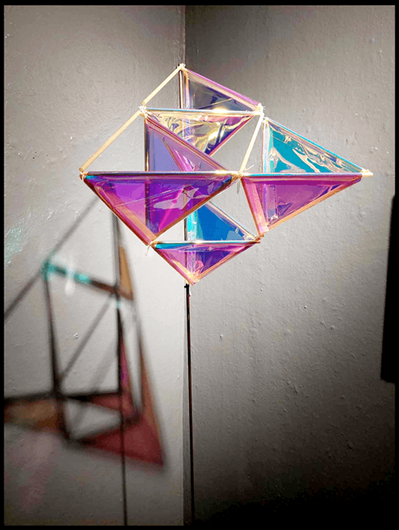 The “Tetrix Kite” of triangular dichroic panels changes color under the gallery lights