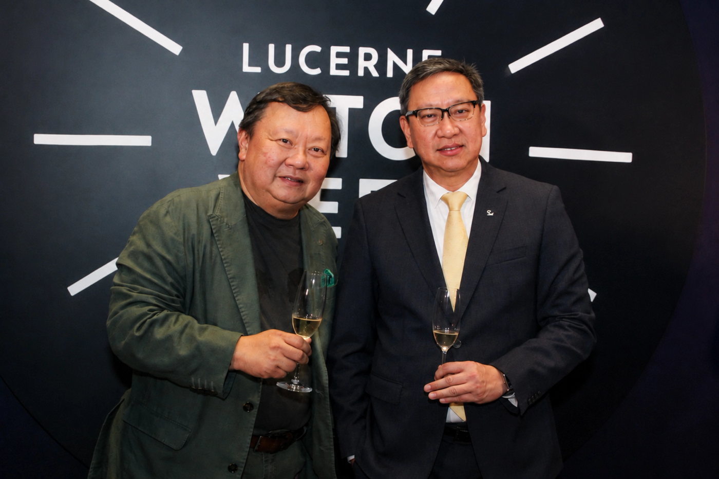 Ivan Yao and Emerson Yao holding champagne flutes at Lucerne Watch Week