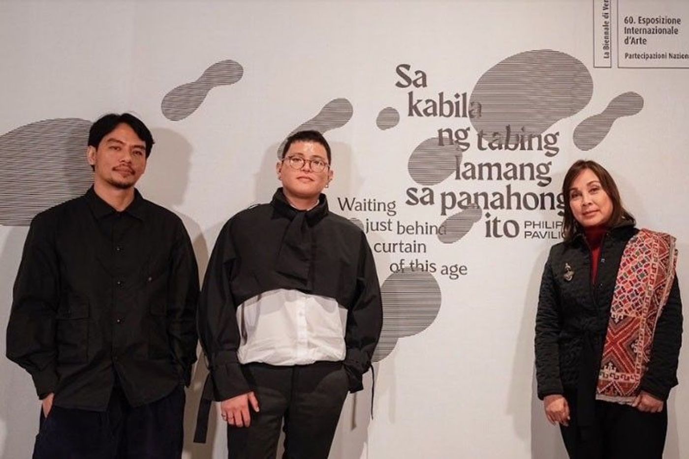 Artist Mark Salvatus, curator Carlos Quijon Jr., and Senator Loren Legarda posing together in the Philippine Pavilion