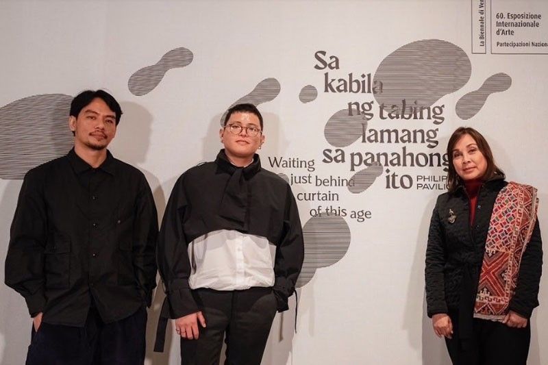Artist Mark Salvatus, curator Carlos Quijon Jr., and Senator Loren Legarda posing together in the Philippine Pavilion