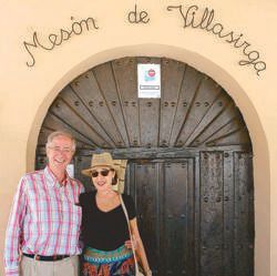Jaime-Axel Ruiz and wife Elise under the arched doorway of the Mesón de Villasirga