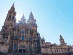 Stone towers and ornate facade of the Santiago de Compostela Cathedral against a clear blue sky