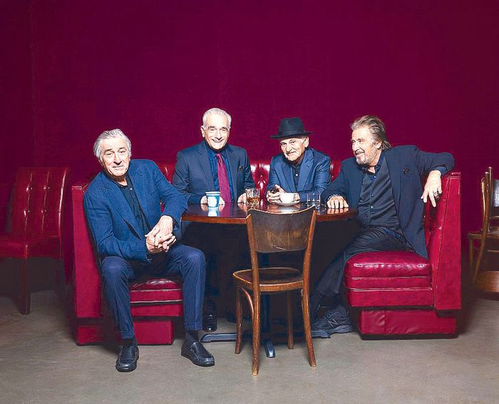 Robert De Niro, Martin Scorsese, Joe Pesci and Al Pacino seated around a table between red leather booths
