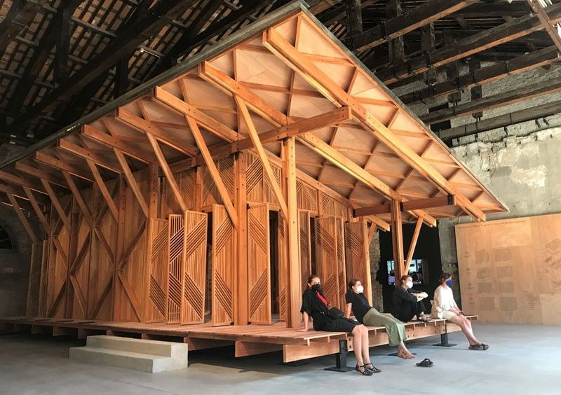 Interior of the Philippine Pavilion at the Venice Architecture Biennale featuring the wooden library structure and daily visitors