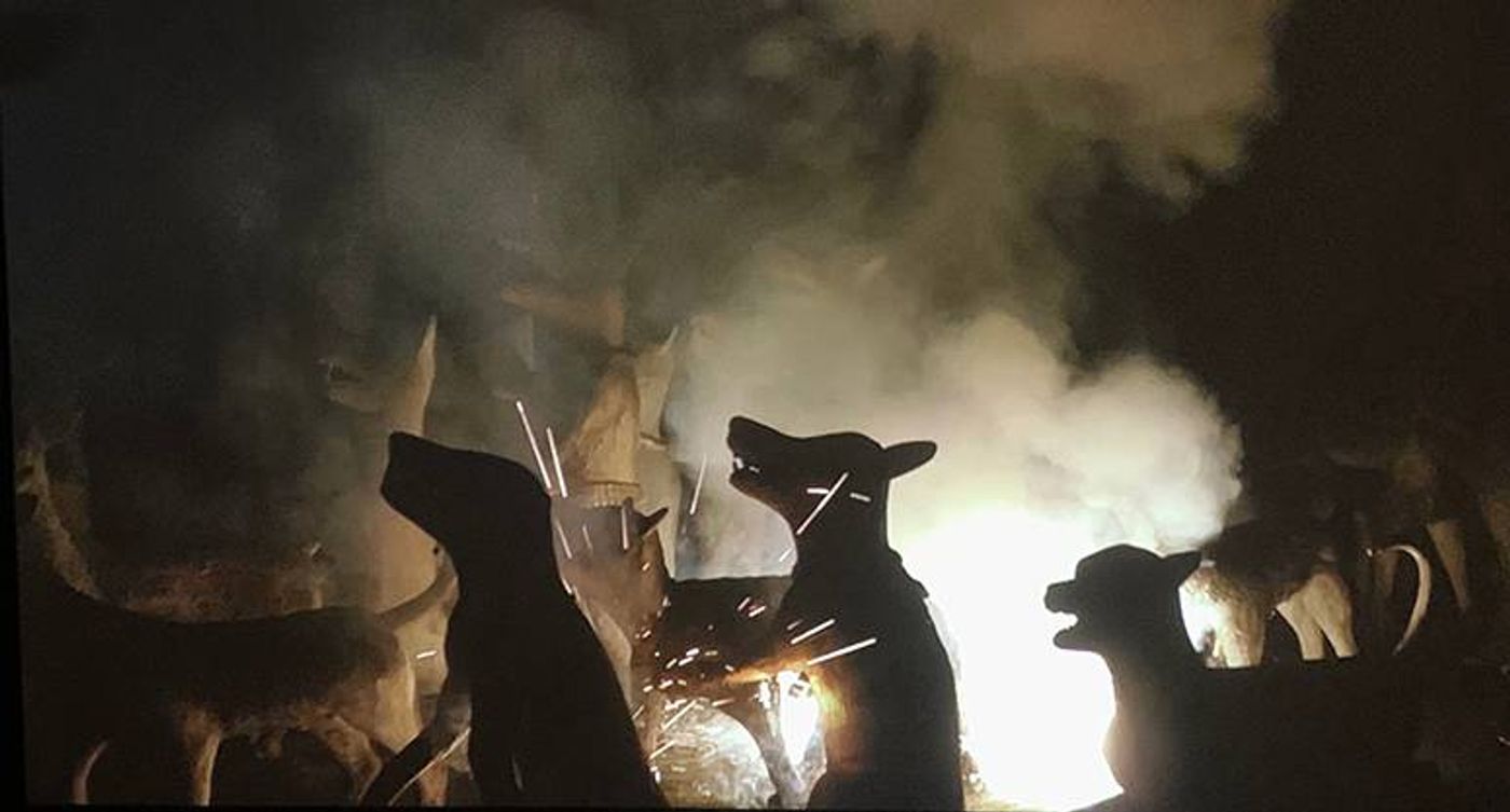 Still from Fireworks (Archives): animal statues silhouetted against sparks and smoke at night
