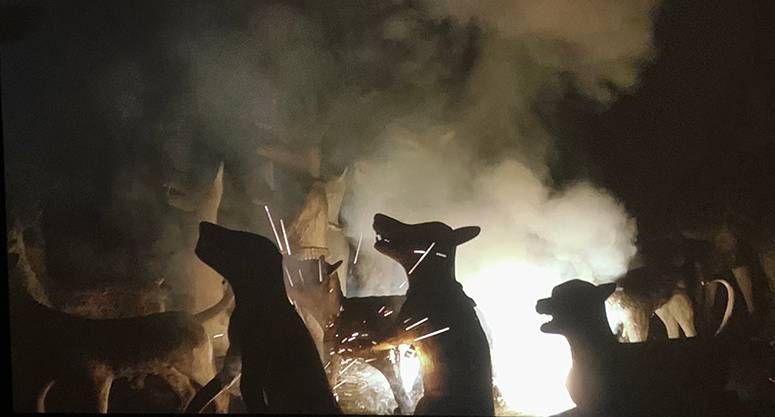 Still from Fireworks (Archives): animal statues silhouetted against sparks and smoke at night
