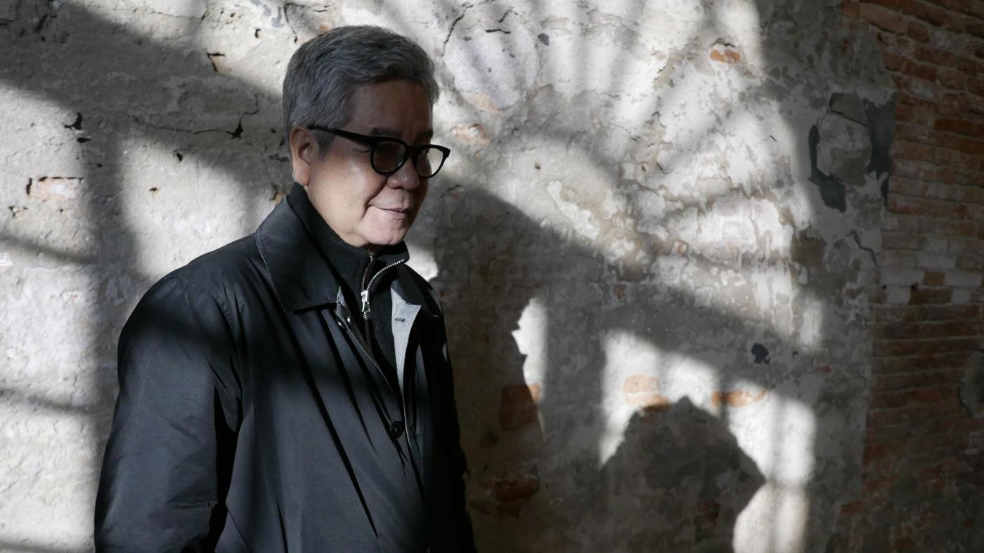 Artist Gerardo Tan standing next to his conceptual installation at the Venice Biennale