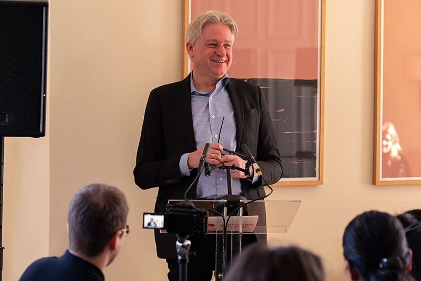 Frankfurter Buchmesse director Juergen Boos smiling at a lectern during the press talk in Berlin
