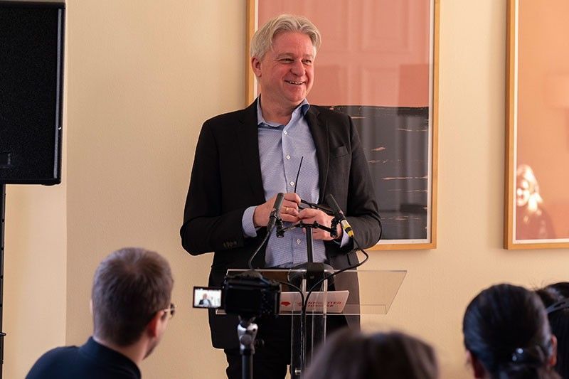 Frankfurter Buchmesse director Juergen Boos smiling at a lectern during the press talk in Berlin
