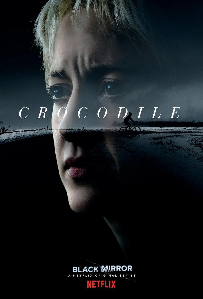 Black Mirror ‘Crocodile’ poster: a woman’s face in half shadow dissolving into a snowbound road where a cyclist rides past