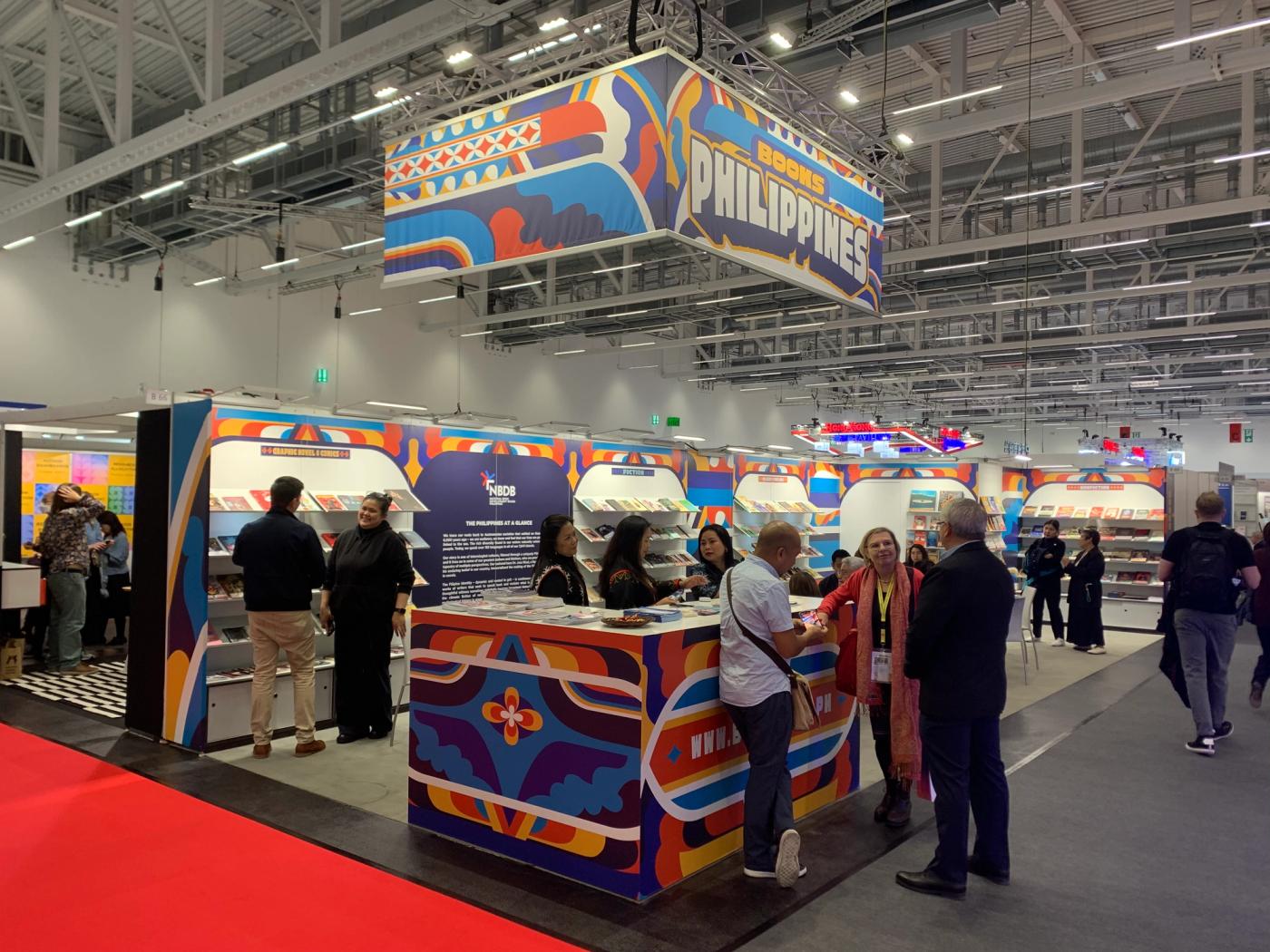 Visitors browse the book-lined Philippine Collective Stand at the 2023 Frankfurt Book Fair