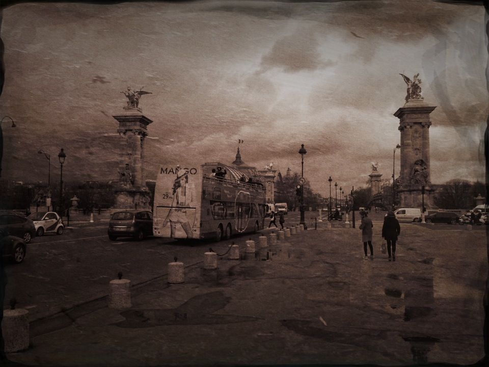 Antique toned street scene of a tour bus crossing a bridge flanked by stone columns with gilded statues