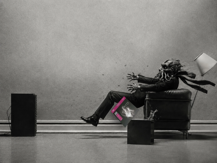 The Maxell “blown away” ad remade with Cthulhu: a suited tentacled listener in a leather armchair blasted backward by a loudspeaker, scarf and lampshade streaming, a record sleeve in his lap