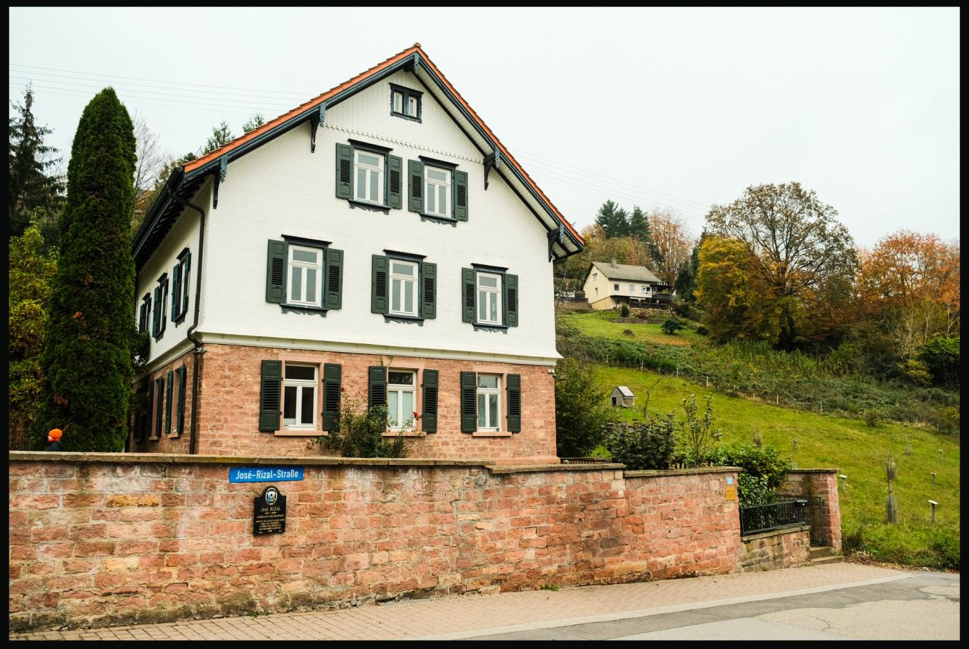 The three storey Ullmer House on Jose-Rizal-Strasse, white shuttered walls over a red sandstone base