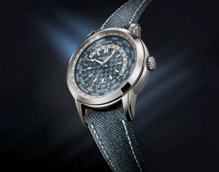 The blue dial Patek Philippe Ref. 5330G-001 World Time watch with denim-patterned calfskin strap, displaying time zones and dates