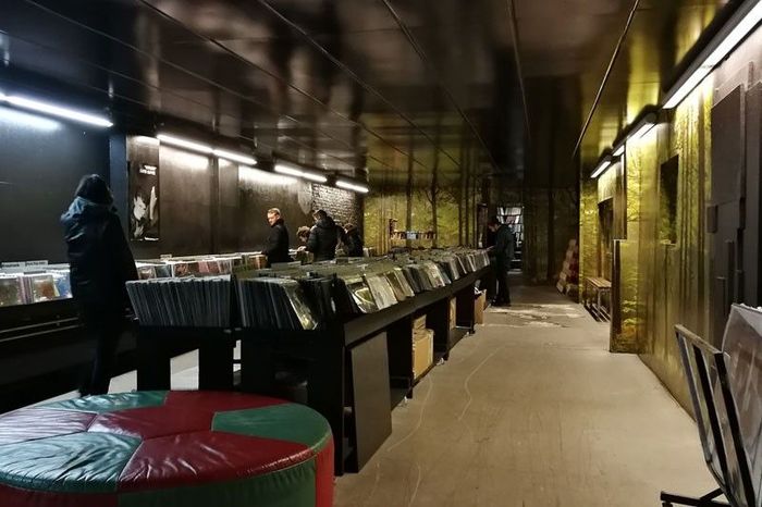Rows of vinyl bins under gold-foil walls in the cavernous Space Hall record store in Berlin