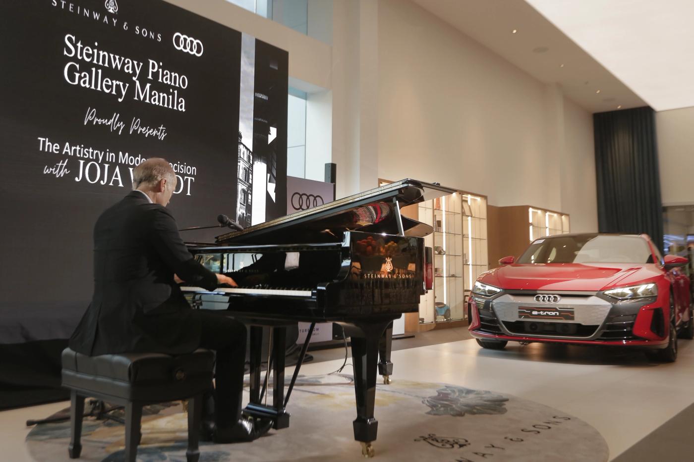 Renowned German pianist Joja Wendt sitting at a grand piano and smiling