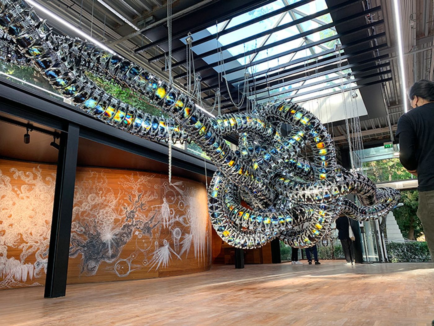 Yunchul Kim’s Chroma V, a giant knotted tube of iridescent metallic scales suspended in a gallery