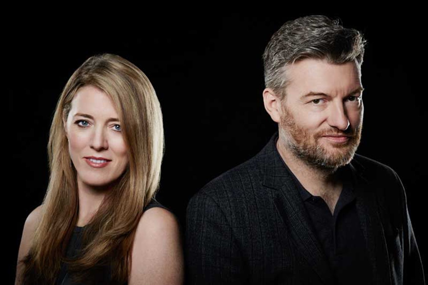 Black Mirror showrunners Annabel Jones and Charlie Brooker posing against a black backdrop