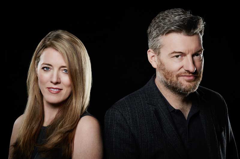 Black Mirror showrunners Annabel Jones and Charlie Brooker posing against a black backdrop