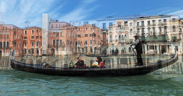 A gondolier steers passengers along a Venetian canal past faded orange palazzi