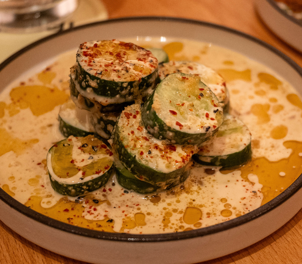 Chilled cucumber rounds in creamy sesame dressing dusted with chili flakes at Ippudo in BGC