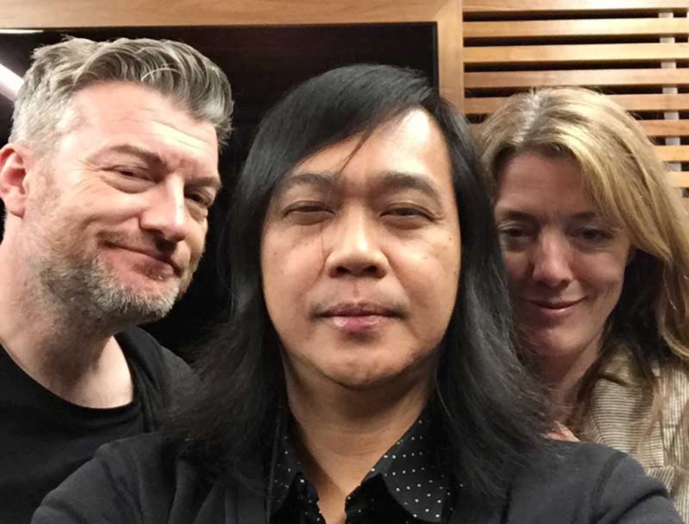Author Igan D’Bayan poses between Charlie Brooker and Annabel Jones at Netflix headquarters