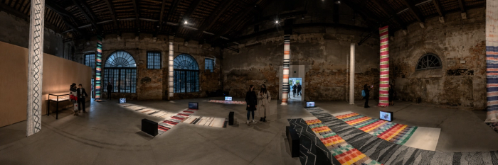 A large, colorful hand-woven tapestry hanging inside the Philippine Pavilion at the Venice Biennale